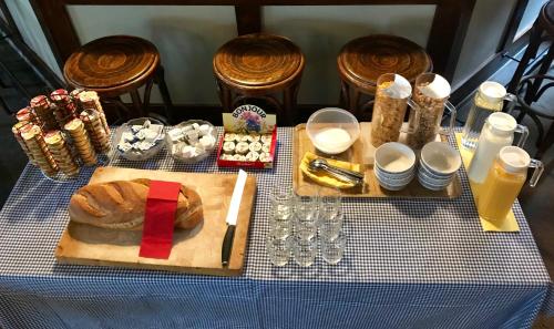 a table with a plate of bread and glasses of orange juice at Happy Inn Lodge in Interlaken