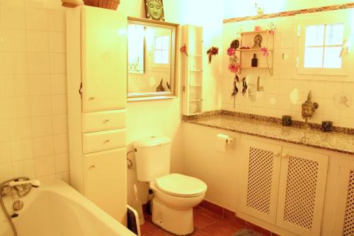 La salle de bains est pourvue de toilettes, d'un lavabo et d'une baignoire. dans l'établissement Casa de los Angeles, à Santa Eulària des Riu