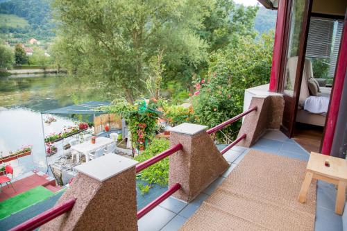a balcony with a view of the water at Villa Dino in Kulen Vakuf