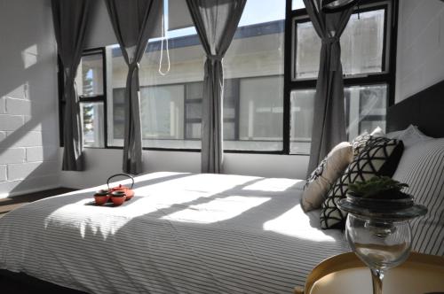 a bedroom with a bed and a window with a windowtaining at The One @ Henley Beach in Grange