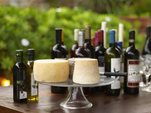 two cakes on a table with bottles of wine at Villa Marandi Luxury Suites in Stelida