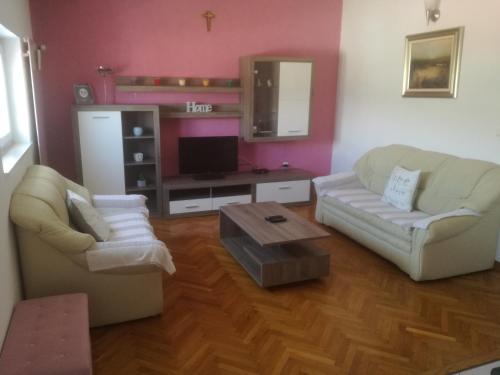 a living room with two chairs and a table at Apartments Lea in Podstrana