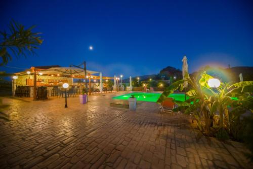 a swimming pool at night with a building at Sea Harmony in Kalathos