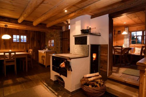 a living room with a stove in a cabin at Chalet Berghaus Bartholomäberg in Bartholomäberg