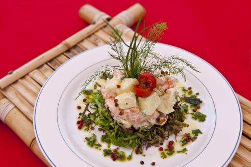 a white plate of food on a red table at Rifoles Praia Hotel e Resort in Natal