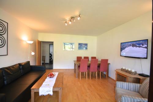 a living room with a couch and a table at Appartements Domizil in Kaprun