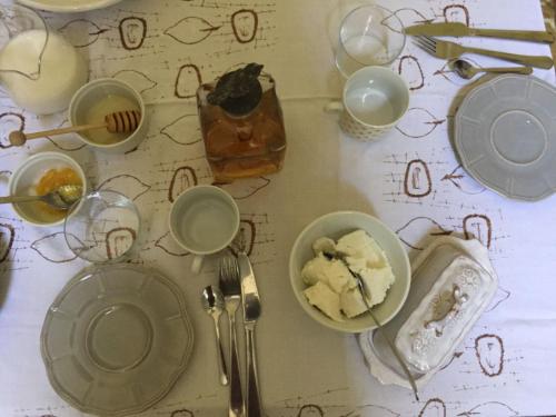 a table topped with plates and bowls of food at B&B Marana 14 Casa di Campagna in Bologna