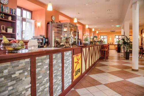 a lobby of a hotel with a counter with food at JUFA Hotel Meersburg am Bodensee in Meersburg