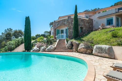 une grande piscine devant une maison dans l'établissement La Veglia, à Porto-Vecchio