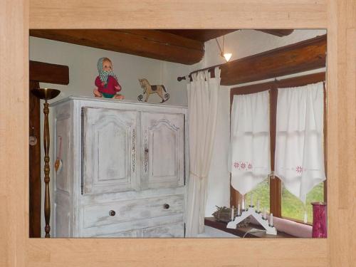 a white cabinet in a room with a window at La Pouponiere in Sainte-Marie-aux-Mines