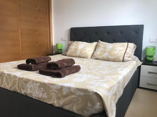 a bedroom with a bed with towels on it at 2 bed apartment on Condado De Alhama with roof solarium N5 in Las Flotas de Butrón