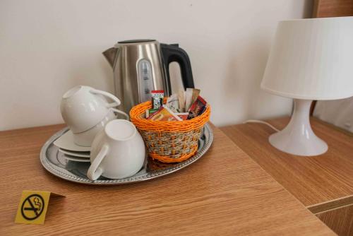 a table with a tea pot and a basket on it at Bucharest Downtown Inn in Bucharest