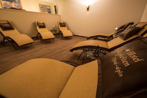 a waiting room with chairs and a book on the floor at Hotel Königsleiten Vital Alpin in Königsleiten