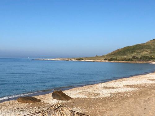 a beach with two large rocks and the ocean at Villa Sciacca Lumia LUNA in Sciacca