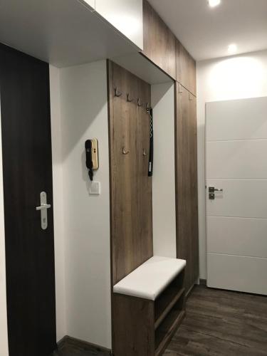 a bathroom with a bench and a cross on the wall at Apartment Kubo in Vranov nad Topľou