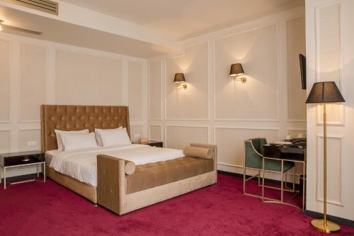 a bedroom with a bed and a desk in it at King Gorgasali in Tbilisi City
