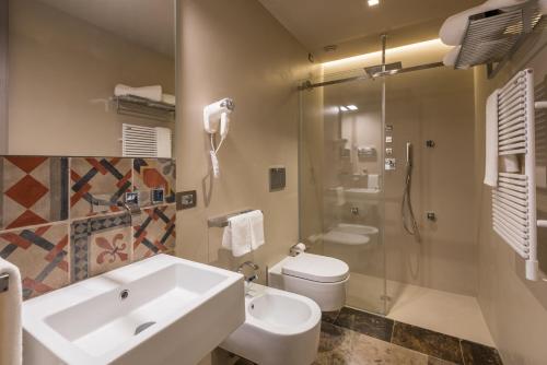 a bathroom with a sink and a toilet and a shower at Villa Boscarino Boutique Hotel & Spa in Ragusa