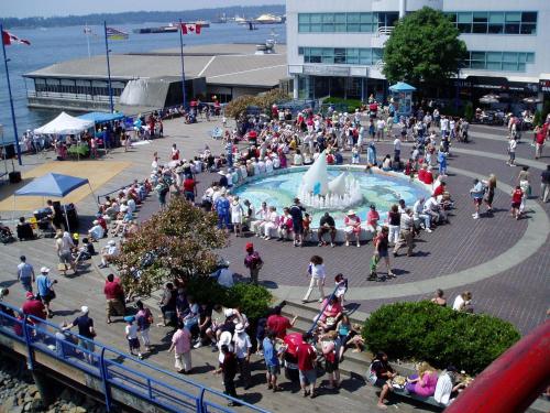 a crowd of people walking around a parking lot at The Lonsdale Quay Hotel in North Vancouver
