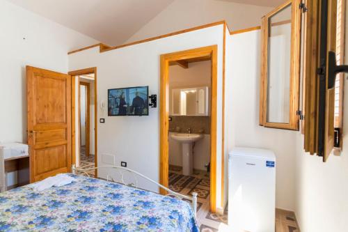 a bedroom with a bed and a sink at Dimora Corte antica in Scorrano