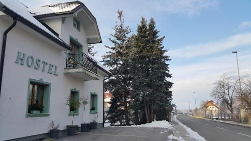 a building on the side of a street with a tree at Mama's House in Cerklje na Gorenjskem