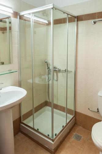a bathroom with a shower and a toilet and a sink at Pallazzo Fortezza in Rethymno Town