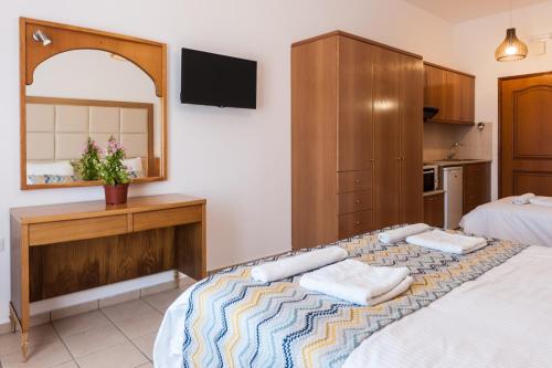 a bedroom with a large bed and a mirror at Pallazzo Fortezza in Rethymno Town
