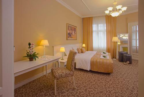 a large hotel room with a bed and a desk at Booking Rooms in Belgrade
