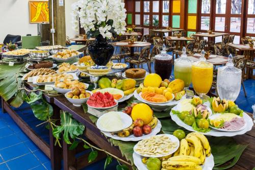 a buffet of fruits and vegetables on a table at Hotel Fazenda Mato Grosso in Cuiabá