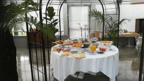 a table with a white table cloth with food on it at Agriturismo Dolce Luna in Milan