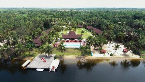 an aerial view of a house on a island in the water at Hotel Coucoue Lodge in Assinie