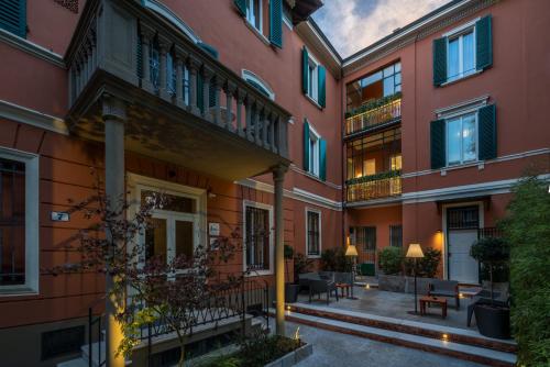 a courtyard of an apartment building with tables and chairs at Mysuiteshome Apartments in Bologna