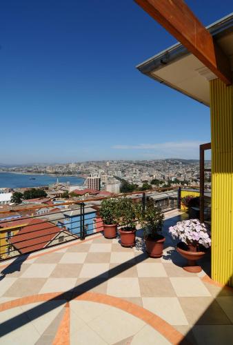a balcony with potted plants on a building at Hotel Boutique Acontraluz in Valparaíso