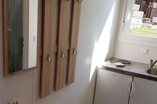 a kitchen with wooden cabinets and a sink and a window at Monteurzimmer Glückstadt in Glückstadt