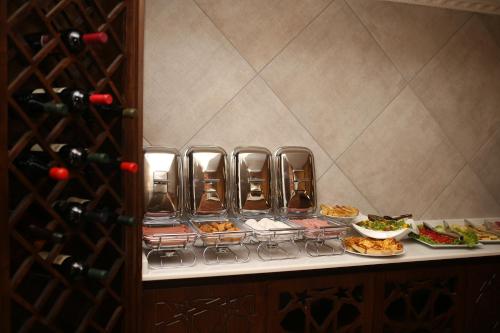 a buffet with a bunch of food and wine bottles at Boutique Hotel Mimino in Tbilisi City