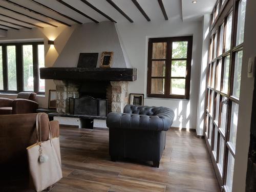 a living room with a couch and a fireplace at Forester in Malmedy