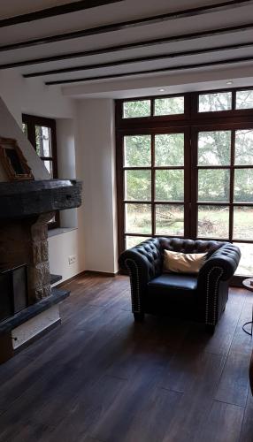 a living room with a couch and a fireplace at Forester in Malmedy