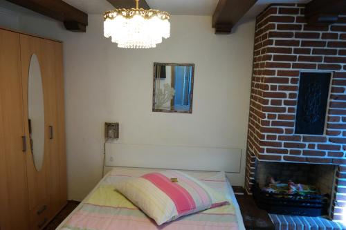a bedroom with a bed next to a brick wall at Am Hallenbad Hotel garni in Ratingen