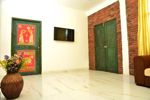 a room with a door and a vase with flowers at Green Ayurvedic Beach Resort in Negombo
