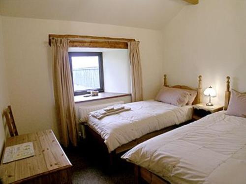 A bed or beds in a room at The Barn 