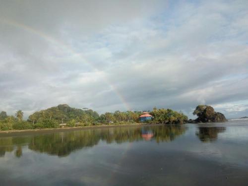 a rainbow in the sky over a body of water at The Hill B&B (El Morro Hosteria) in El Valle