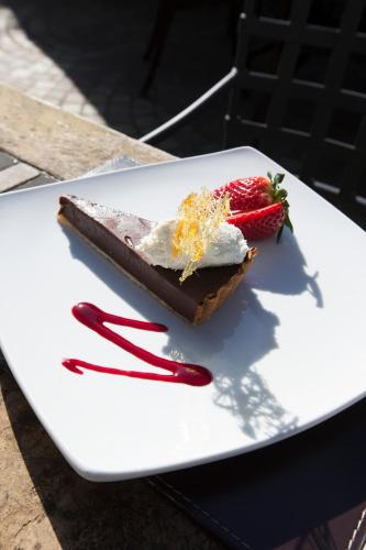 a piece of chocolate dessert with strawberries on a white plate at Redcliffe Hotel in Inverness