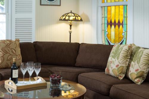 a living room with a couch and a table with wine glasses at Magnolia Springs Bed and Breakfast in Magnolia Springs