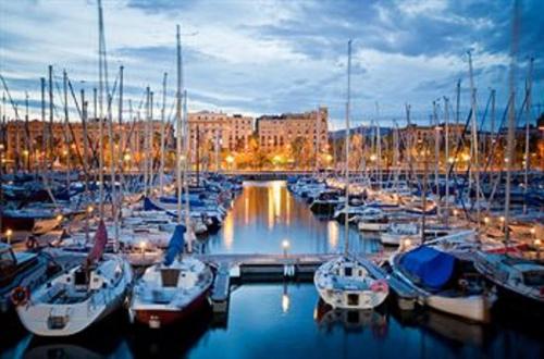 a group of boats docked in a marina at night at Great Spacious Apartment in the Gothic District City Center in Barcelona