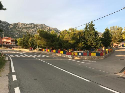 an empty street with a fence on the side of the road at Apartman Nadia in Karlobag