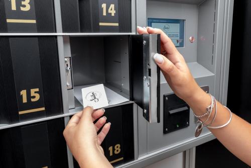a person is putting money in a machine at Mysuiteshome Apartments in Bologna