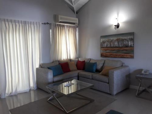 a living room with a couch and a table at Christar Villas Hotel in Kingston