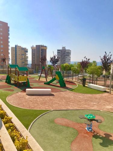 a park with a playground with a swing at Sunset Drive Vistas Magicas in Benidorm