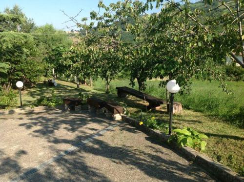 a group of park benches sitting in a park at Agriturismo Bellavista in Arsita