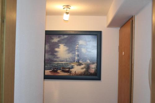 a painting of a lighthouse on a wall at Grüner Blick in Witten