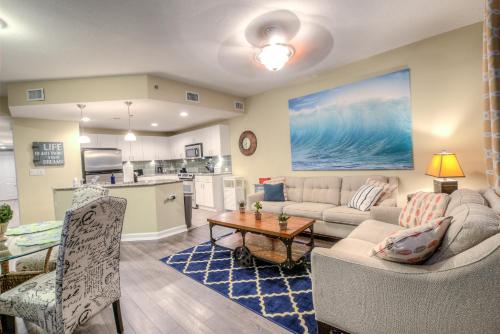 a living room with a couch and a table at Grand Panama Resort 2-202 By Aneliya in Panama City Beach